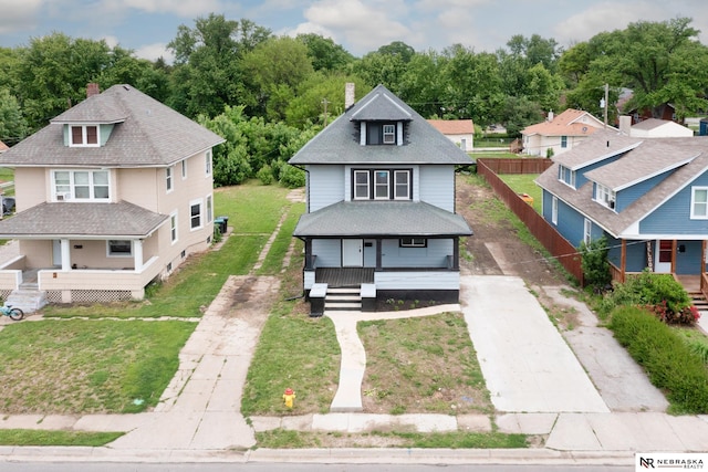 2306 Ogden St, Omaha, NE 68110 - view of front of home with covered porch, driveway, a chimney, and roof with shingles