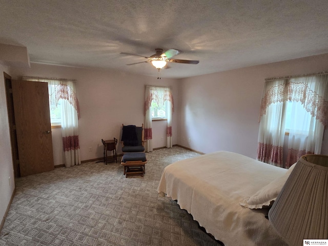 35 E Sandy Ridge Rd, Columbus, NE 68601 - bedroom with baseboards, carpet floors, a textured ceiling, and ceiling fan