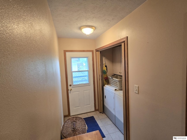 35 E Sandy Ridge Rd, Columbus, NE 68601 - entryway with washer and clothes dryer, a textured wall, light tile patterned flooring, and a textured ceiling