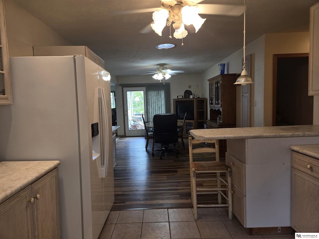 35 E Sandy Ridge Rd, Columbus, NE 68601 - kitchen featuring white refrigerator with ice dispenser, a ceiling fan, light countertops, light tile patterned flooring, and hanging light fixtures