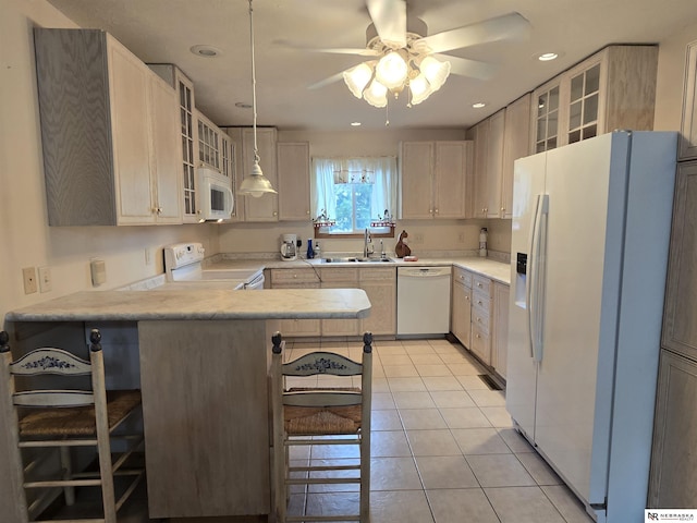 35 E Sandy Ridge Rd, Columbus, NE 68601 - kitchen with white appliances, a sink, a peninsula, a ceiling fan, and light countertops