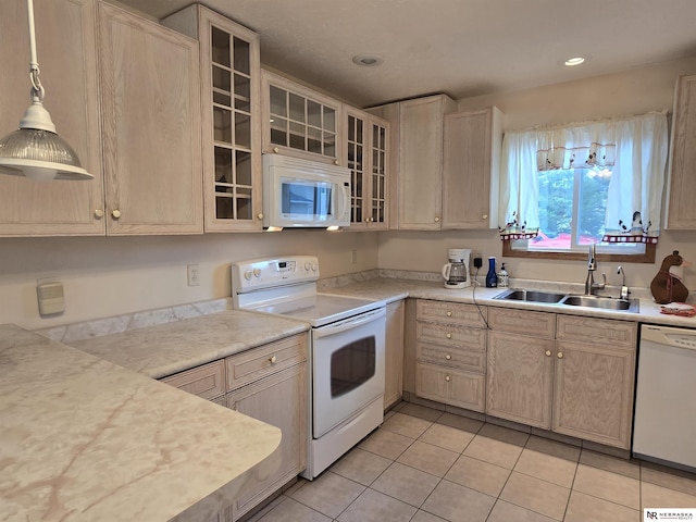 35 E Sandy Ridge Rd, Columbus, NE 68601 - kitchen with white appliances, a sink, light tile patterned flooring, light countertops, and glass insert cabinets