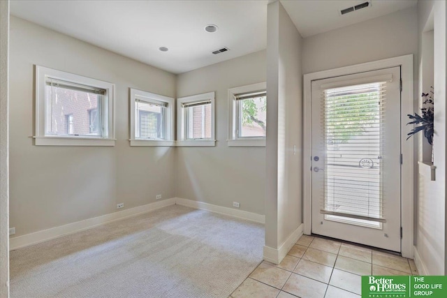 917 S 10th Ct, Omaha, NE 68108 - entryway featuring baseboards, light tile patterned floors, and light carpet