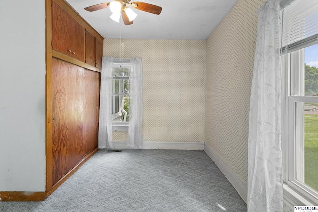 1373 S St, Blair, NE 68008 - unfurnished bedroom with wallpapered walls, baseboards, carpet floors, and a ceiling fan