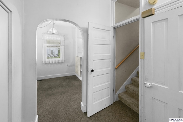 1373 S St, Blair, NE 68008 - hall featuring dark colored carpet, stairs, arched walkways, and baseboards
