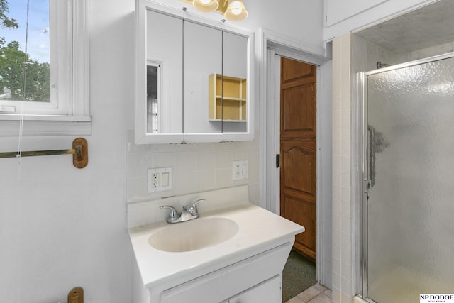 1373 S St, Blair, NE 68008 - bathroom featuring vanity, a shower stall, tasteful backsplash, and tile walls