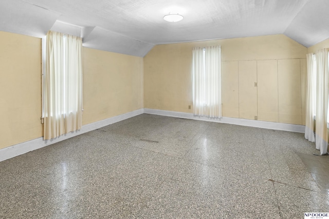 1373 S St, Blair, NE 68008 - additional living space with lofted ceiling, baseboards, and speckled floor
