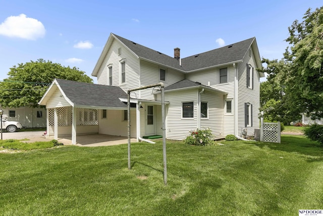 1373 S St, Blair, NE 68008 - back of property with a patio area, a lawn, a chimney, and roof with shingles