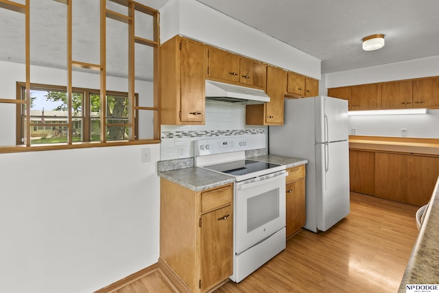 9607 Spencer St, Omaha, NE 68134 - kitchen with white appliances, under cabinet range hood, backsplash, light wood-type flooring, and brown cabinets