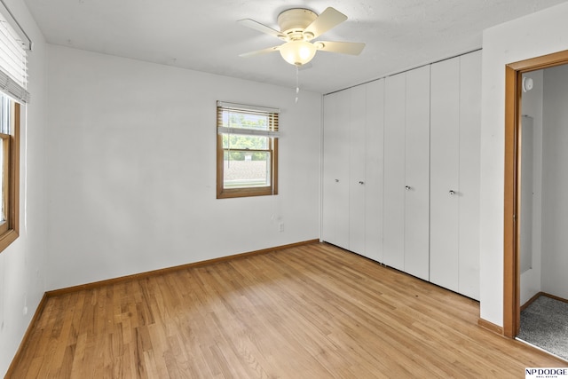9607 Spencer St, Omaha, NE 68134 - unfurnished bedroom featuring light wood finished floors, a closet, and baseboards