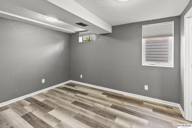 9607 Spencer St, Omaha, NE 68134 - basement with wood finished floors, baseboards, and a textured ceiling
