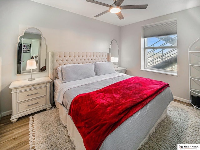 139 N 11th St Unit 905, Lincoln, NE 68508 - bedroom featuring wood finished floors, baseboards, and ceiling fan