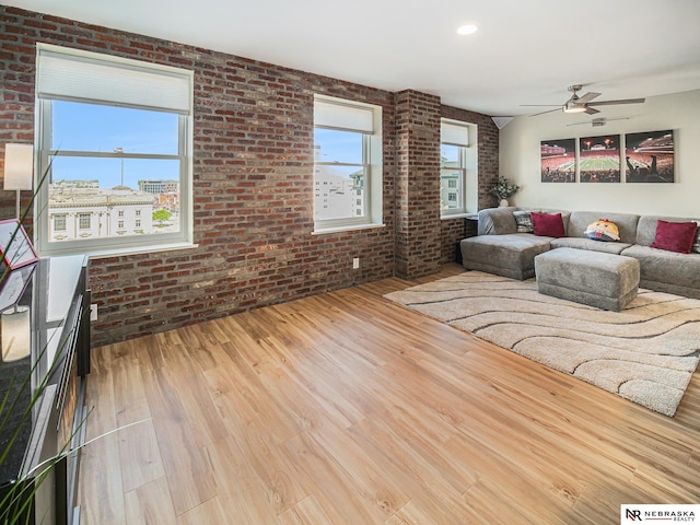 139 N 11th St Unit 905, Lincoln, NE 68508 - living room with brick wall, wood finished floors, and a ceiling fan