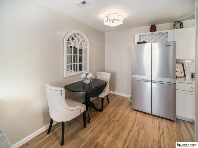 139 N 11th St Unit 905, Lincoln, NE 68508 - dining space featuring baseboards and light wood-style flooring