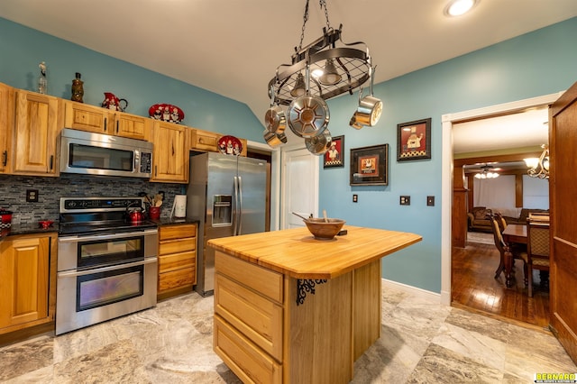102 Eldon St, Talmage, NE 68448 - kitchen with appliances with stainless steel finishes, wooden counters, decorative backsplash, a kitchen island, and ceiling fan