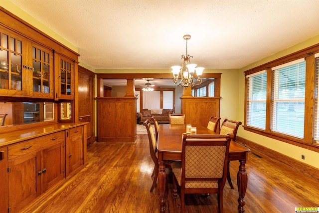 102 Eldon St, Talmage, NE 68448 - dining room with dark wood-type flooring, a chandelier, baseboards, and ceiling fan