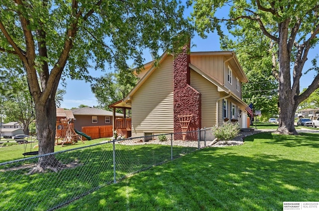 12555 Ohern St, Omaha, NE 68137 - view of home's exterior with a playground, a chimney, and a garage