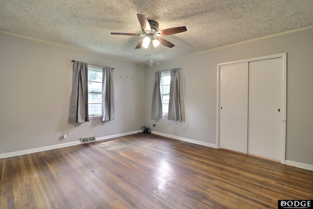 1827 E Broad St, Fremont, NE 68025 - unfurnished bedroom with ornamental molding, wood finished floors, a textured ceiling, a closet, and baseboards