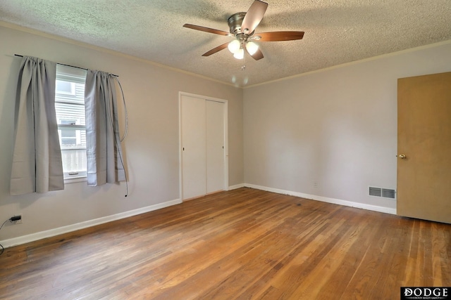 1827 E Broad St, Fremont, NE 68025 - spare room featuring a textured ceiling, ceiling fan, wood finished floors, baseboards, and crown molding