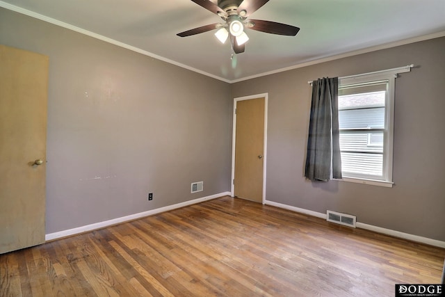 1827 E Broad St, Fremont, NE 68025 - spare room featuring ceiling fan, baseboards, wood finished floors, and ornamental molding