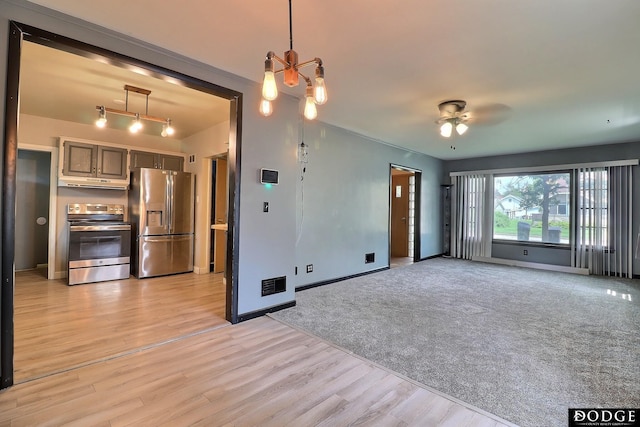 1827 E Broad St, Fremont, NE 68025 - unfurnished living room featuring a ceiling fan, light wood-style floors, and baseboards