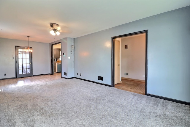 1827 E Broad St, Fremont, NE 68025 - spare room featuring light carpet, baseboards, ceiling fan, and light wood-style floors