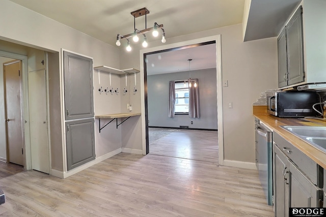 1827 E Broad St, Fremont, NE 68025 - kitchen with stainless steel dishwasher, light wood finished floors, and gray cabinetry