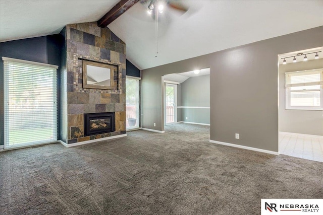 15161 R St, Omaha, NE 68137 - unfurnished living room with a ceiling fan, plenty of natural light, a tiled fireplace, and carpet floors
