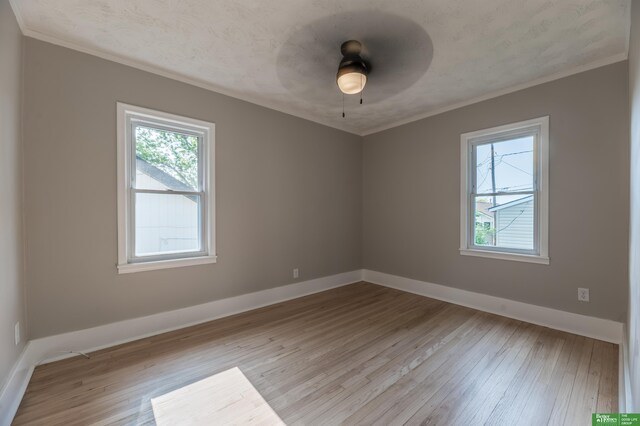 5515 Hickory St, Omaha, NE 68106 - unfurnished room with ornamental molding, wood finished floors, baseboards, and ceiling fan