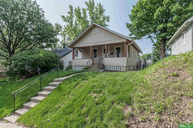 5515 Hickory St, Omaha, NE 68106 - bungalow-style house featuring covered porch and a front yard