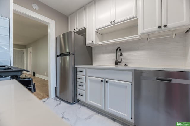 5515 Hickory St, Omaha, NE 68106 - kitchen featuring stainless steel appliances, a sink, light countertops, and decorative backsplash