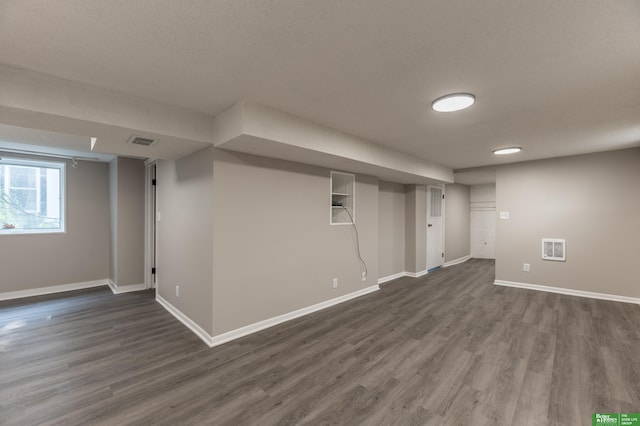 5515 Hickory St, Omaha, NE 68106 - basement with dark wood-type flooring and baseboards