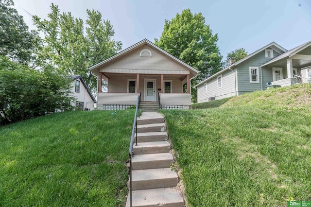 5515 Hickory St, Omaha, NE 68106 - view of front of property with covered porch and a front lawn