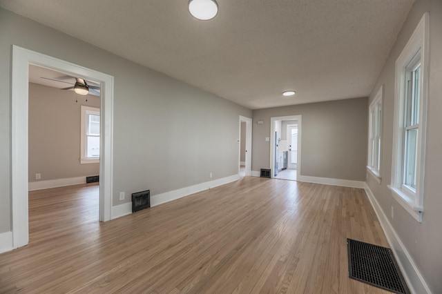 5515 Hickory St, Omaha, NE 68106 - empty room featuring light wood-style flooring, baseboards, and a ceiling fan