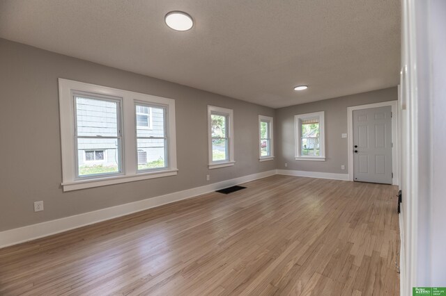 5515 Hickory St, Omaha, NE 68106 - foyer featuring light wood finished floors, baseboards, and a textured ceiling