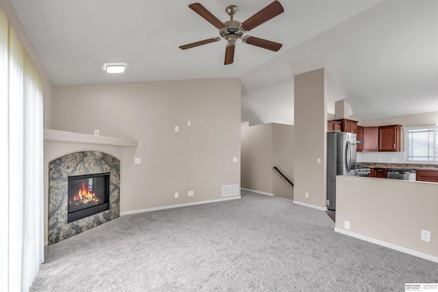16421 Redman Ave, Omaha, NE 68116 - unfurnished living room featuring lofted ceiling, light carpet, ceiling fan, a high end fireplace, and baseboards