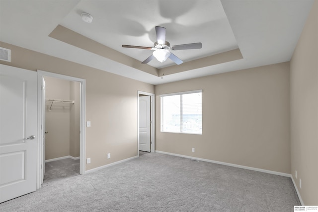16421 Redman Ave, Omaha, NE 68116 - unfurnished bedroom featuring carpet, a raised ceiling, baseboards, and a spacious closet