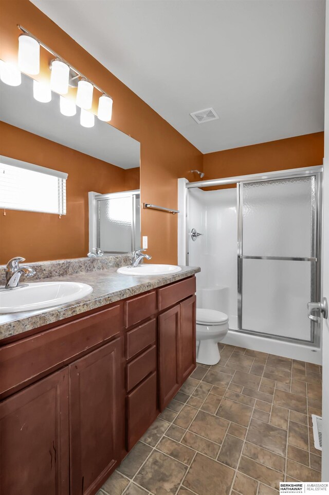 16421 Redman Ave, Omaha, NE 68116 - full bathroom featuring a shower stall, double vanity, and toilet