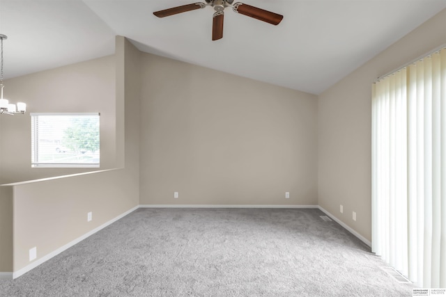16421 Redman Ave, Omaha, NE 68116 - carpeted spare room with vaulted ceiling, ceiling fan, a chandelier, and baseboards