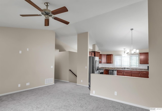 16421 Redman Ave, Omaha, NE 68116 - kitchen featuring appliances with stainless steel finishes, a sink, lofted ceiling, light countertops, and light carpet