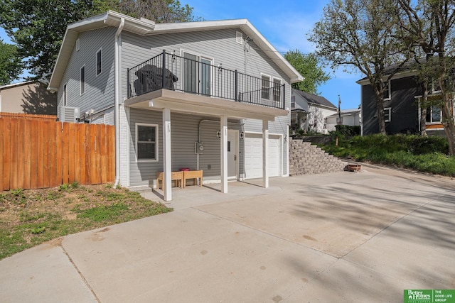 601 5th Ave, Plattsmouth, NE 68048 - view of front of home featuring a balcony, an attached garage, and driveway