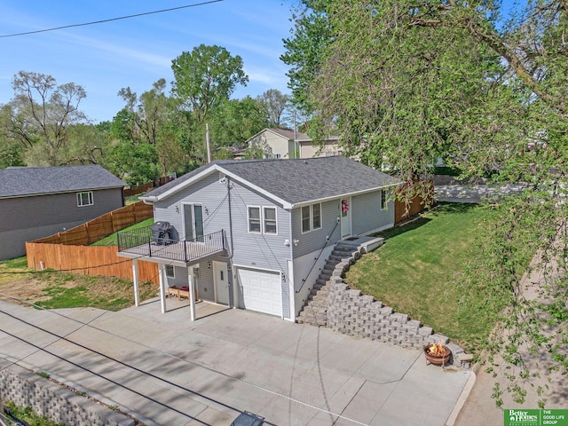 601 5th Ave, Plattsmouth, NE 68048 - ranch-style house with concrete driveway, a garage, an outdoor fire pit, and roof with shingles