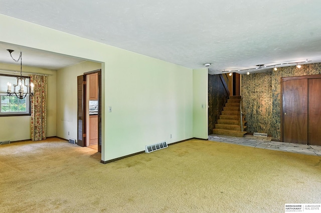 3629 S 114th Ave, Omaha, NE 68144 - unfurnished living room with carpet, a chandelier, and stairs