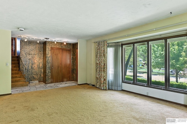 3629 S 114th Ave, Omaha, NE 68144 - carpeted empty room featuring stairway and a textured ceiling