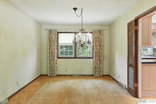 3629 S 114th Ave, Omaha, NE 68144 - unfurnished dining area featuring carpet floors and a chandelier