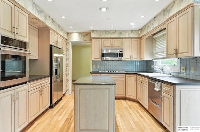 3629 S 114th Ave, Omaha, NE 68144 - kitchen featuring appliances with stainless steel finishes, light brown cabinets, light wood-type flooring, a kitchen island, and recessed lighting