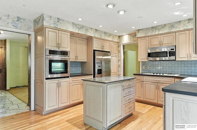 3629 S 114th Ave, Omaha, NE 68144 - kitchen with appliances with stainless steel finishes, light brown cabinets, dark countertops, light wood finished floors, and recessed lighting