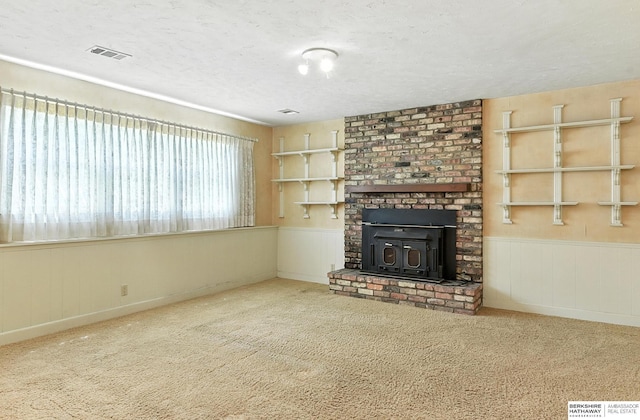 3629 S 114th Ave, Omaha, NE 68144 - unfurnished living room with a textured ceiling, carpet floors, and a wainscoted wall