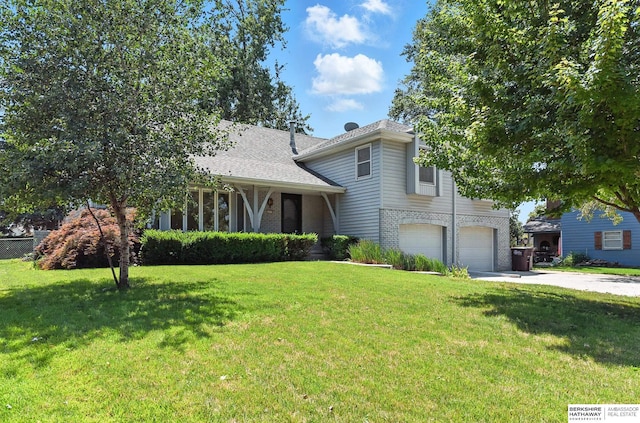 3629 S 114th Ave, Omaha, NE 68144 - view of front of home featuring an attached garage, concrete driveway, a front yard, and brick siding