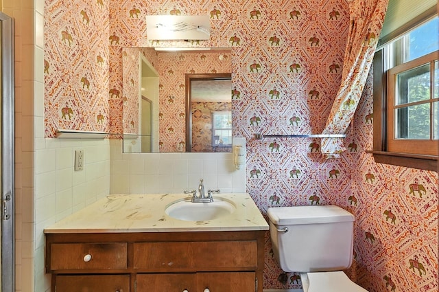 3629 S 114th Ave, Omaha, NE 68144 - bathroom with vanity, tile walls, and decorative backsplash